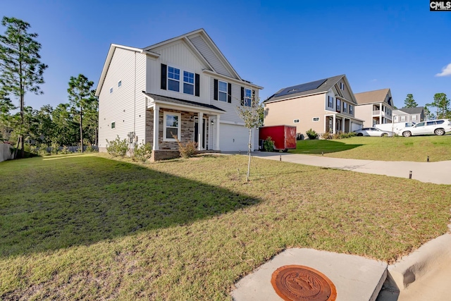 view of front of property with a front yard and a garage