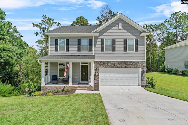 view of front of property featuring a front lawn, a porch, and a garage