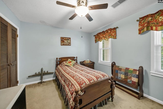 bedroom featuring multiple windows, carpet, and a closet