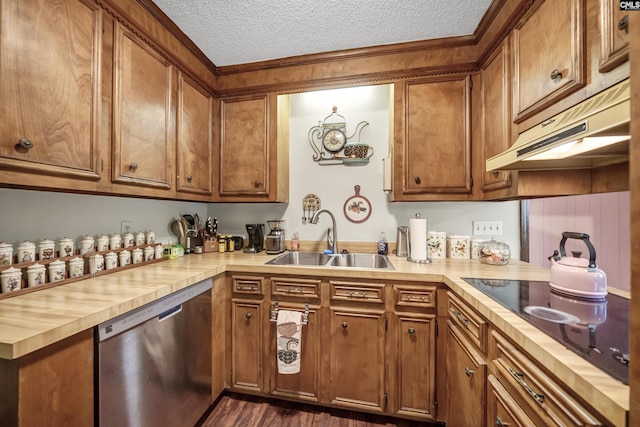 kitchen with brown cabinets, a sink, a textured ceiling, dishwasher, and under cabinet range hood