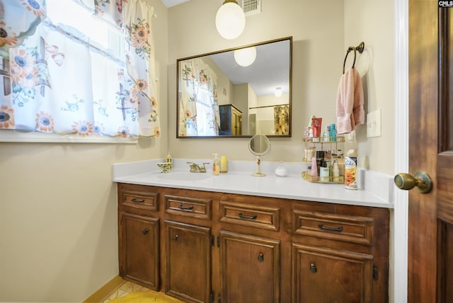 bathroom featuring visible vents, vanity, and baseboards