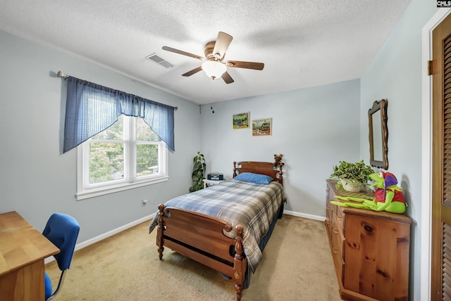 bedroom featuring light carpet, a textured ceiling, visible vents, and baseboards