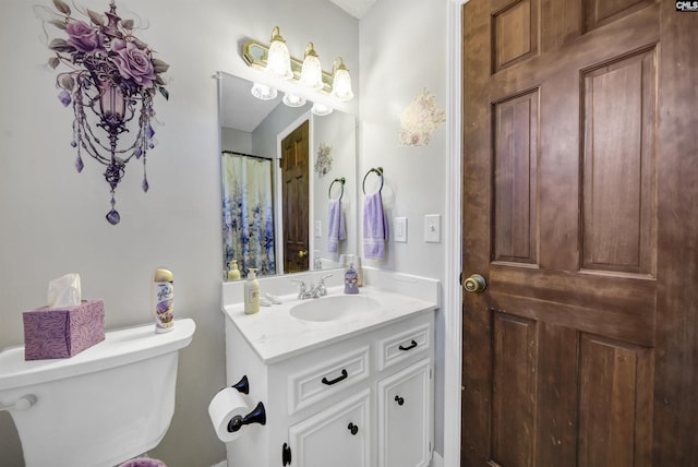 bathroom with toilet and vanity