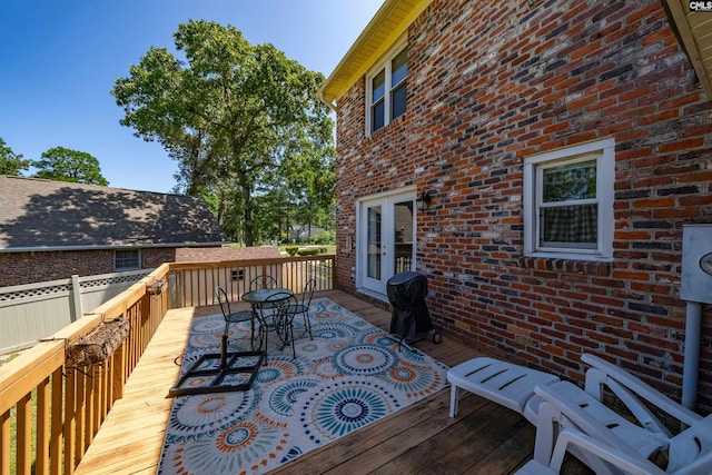 deck featuring french doors and a grill