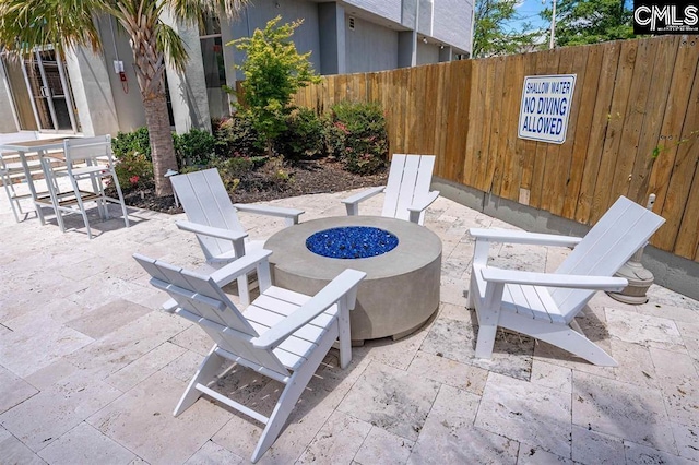 view of patio with a fire pit