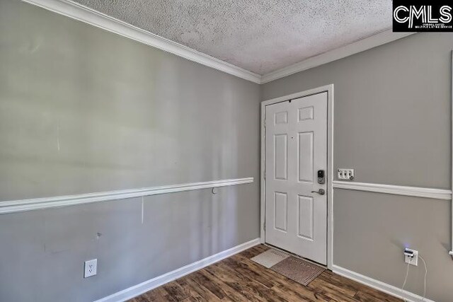 entrance foyer featuring hardwood / wood-style floors, ornamental molding, and a textured ceiling