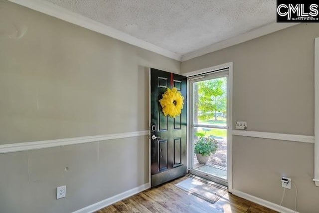 foyer entrance with hardwood / wood-style flooring and a textured ceiling