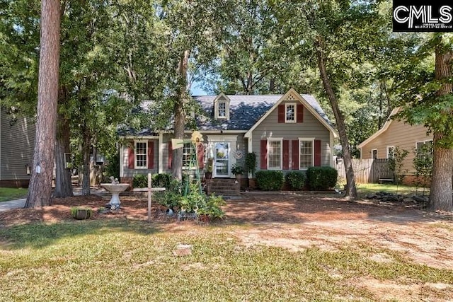 cape cod home with a front lawn