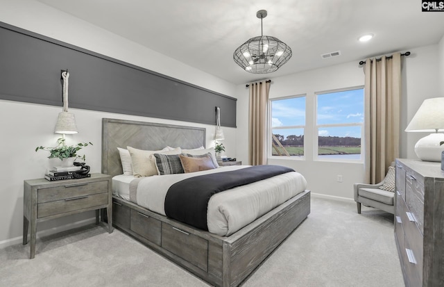 carpeted bedroom with a chandelier