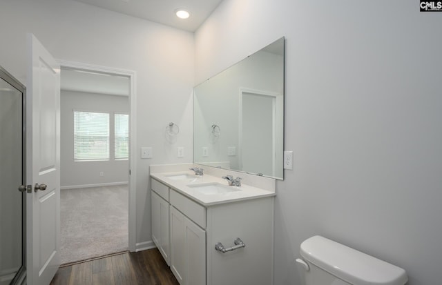 bathroom with hardwood / wood-style flooring, vanity, and toilet