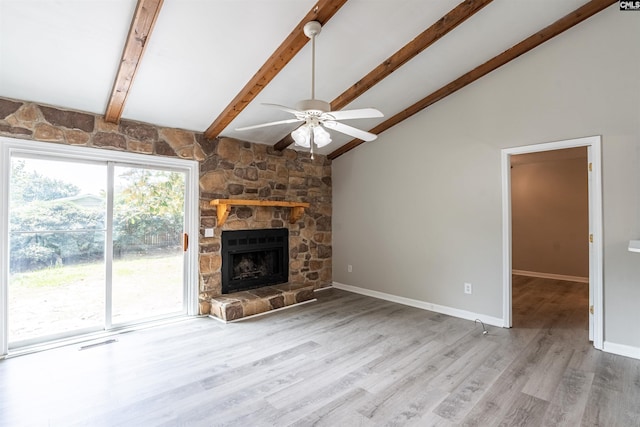 unfurnished living room featuring hardwood / wood-style flooring, a fireplace, vaulted ceiling with beams, and ceiling fan