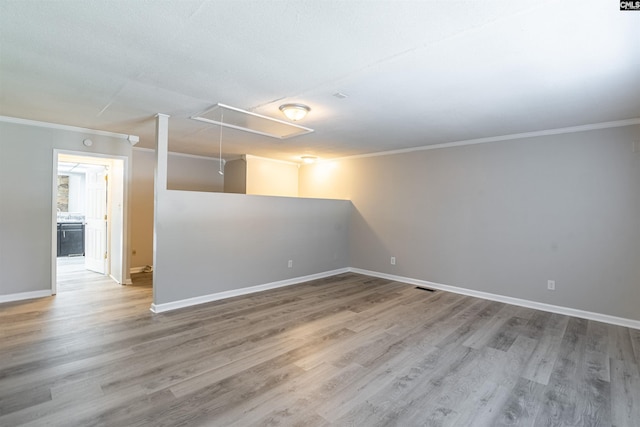 empty room featuring crown molding and hardwood / wood-style floors