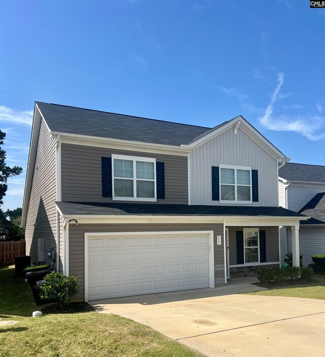 front facade with a garage and a front yard