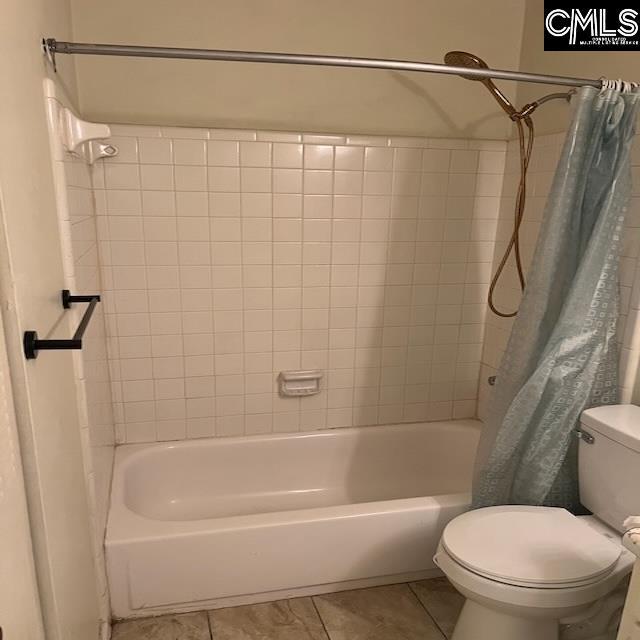 1208 Bush River Rd Unit F-7, Columbia, SC 29210 - full bathroom featuring toilet, tile patterned flooring, and shower / bath combination with curtain