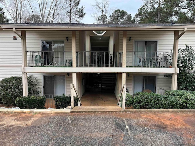 view of property featuring a balcony and a carport