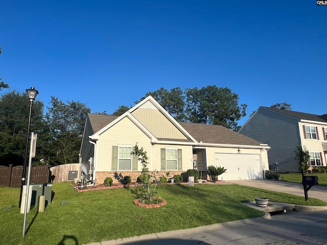 view of front of home with a garage, brick siding, fence, driveway, and a front lawn