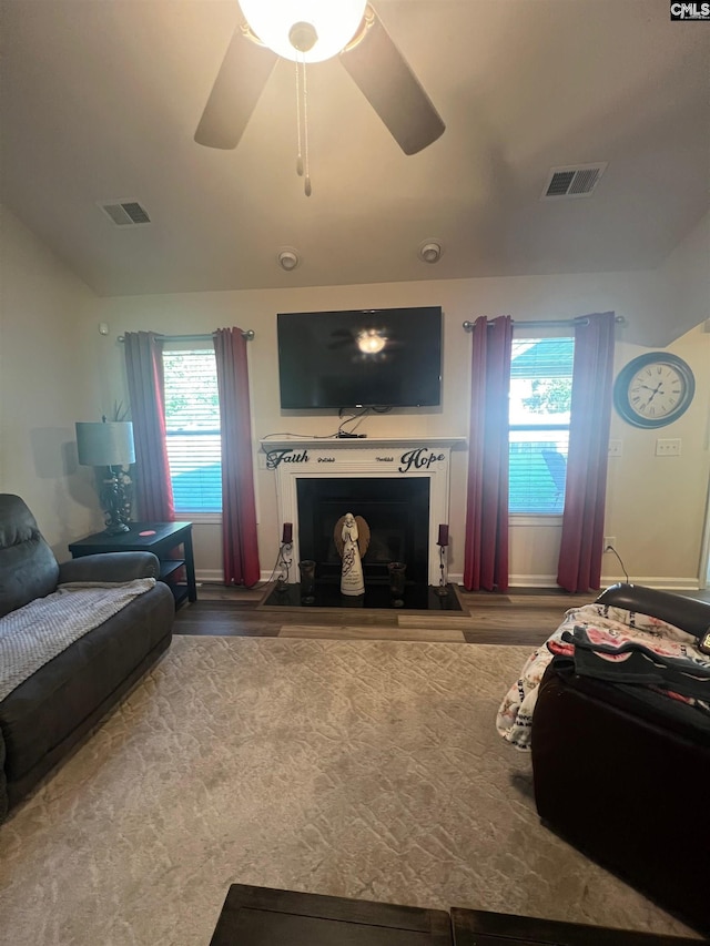 living room with a fireplace, visible vents, and a healthy amount of sunlight