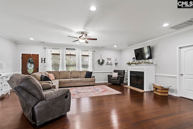 living room featuring ceiling fan, crown molding, and dark hardwood / wood-style floors