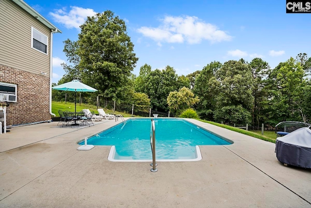 view of pool with a lawn and a patio area