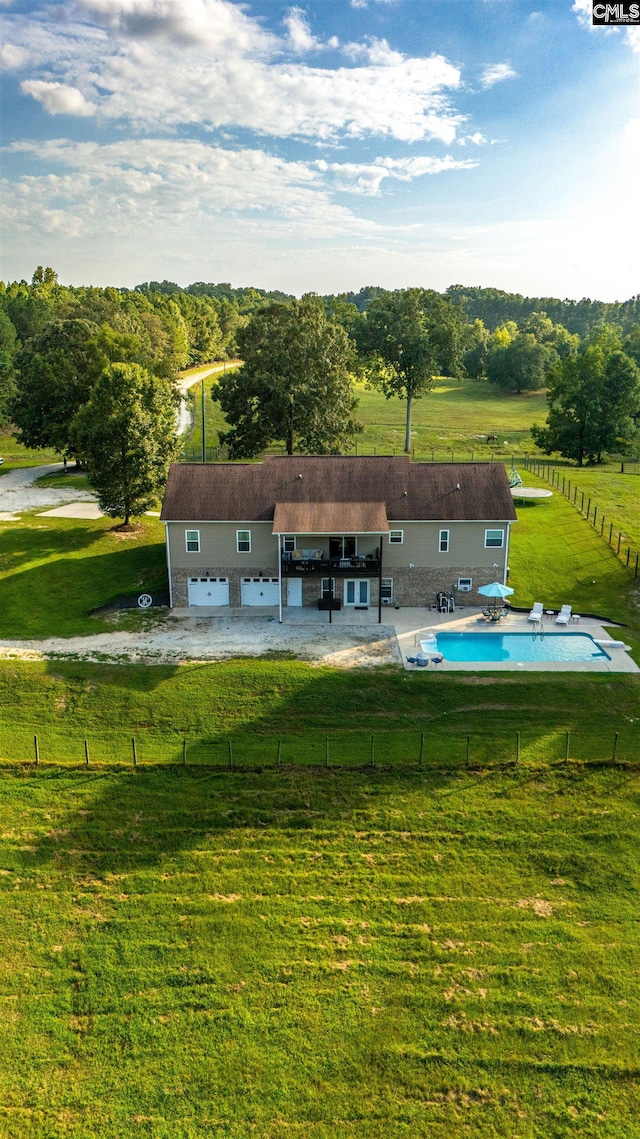 view of yard with a patio area, a rural view, and a fenced in pool