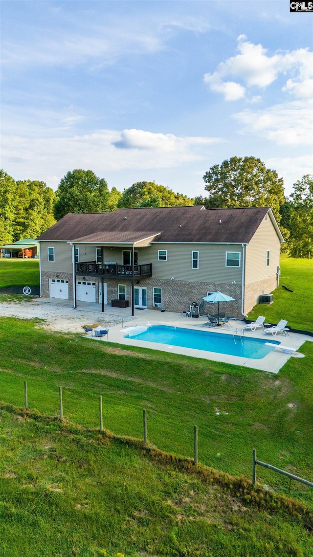 back of house featuring a lawn and a patio area