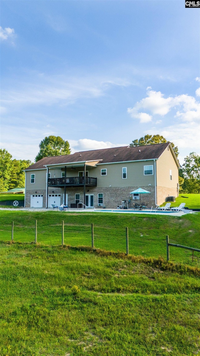 rear view of house featuring a lawn