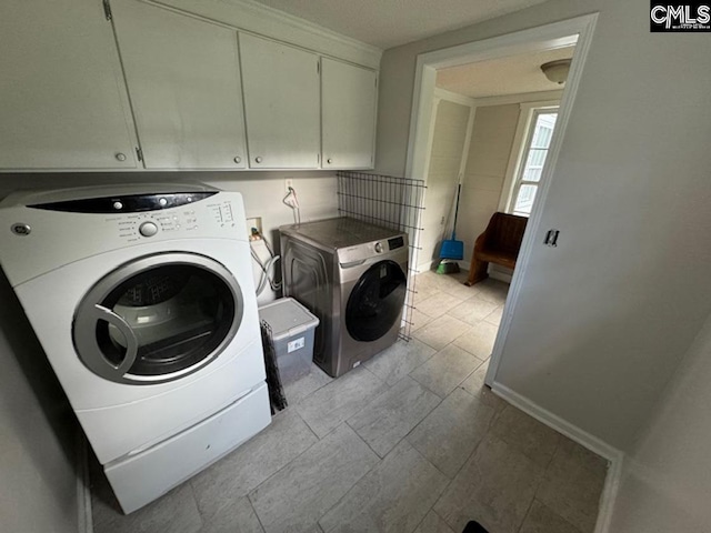 washroom with cabinets, independent washer and dryer, and light tile patterned floors