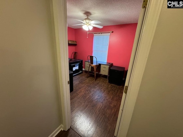 office featuring ceiling fan, a textured ceiling, and dark wood-type flooring