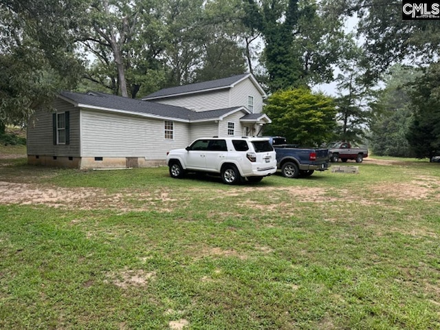 view of side of home featuring a yard