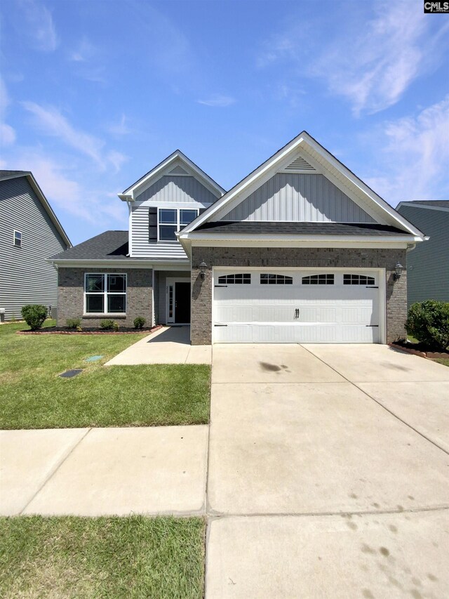 craftsman inspired home with a garage and a front yard