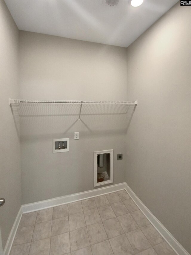 clothes washing area with hookup for a washing machine, light tile patterned floors, and electric dryer hookup