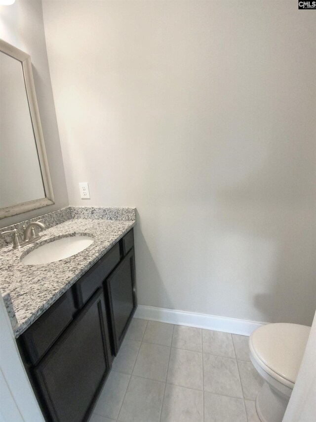 bathroom featuring vanity, toilet, and tile patterned floors