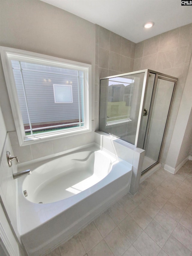 bathroom with separate shower and tub and tile patterned floors