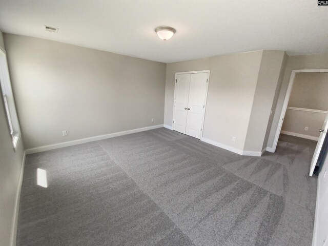 unfurnished bedroom featuring a closet and carpet floors