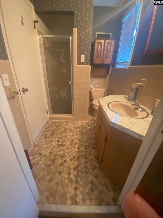 bathroom featuring backsplash, walk in shower, toilet, tile walls, and vanity