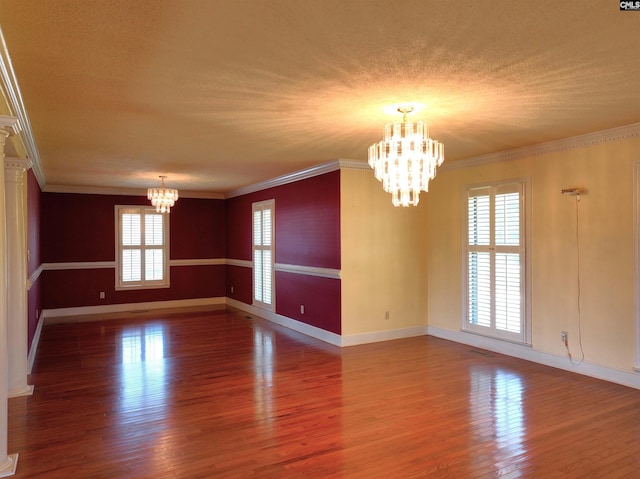 unfurnished room with ornamental molding, dark hardwood / wood-style flooring, and a notable chandelier