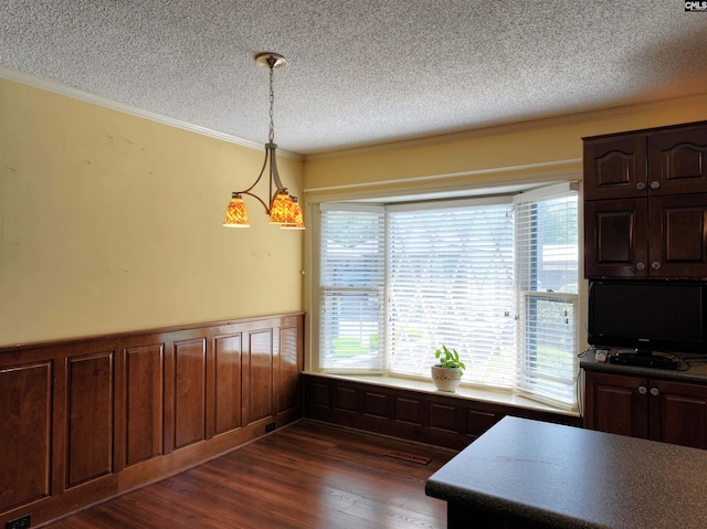 dining area with a textured ceiling, plenty of natural light, crown molding, and dark wood-type flooring