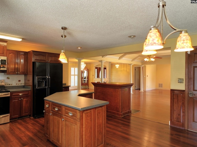 kitchen with ornate columns, open floor plan, black refrigerator with ice dispenser, and a center island