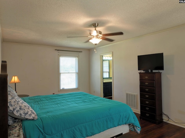 bedroom featuring a textured ceiling, visible vents, ceiling fan, and dark wood finished floors