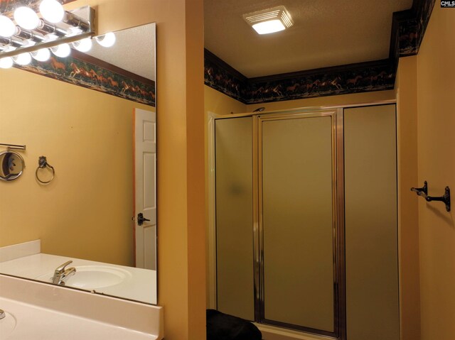 full bathroom with a stall shower and a sink