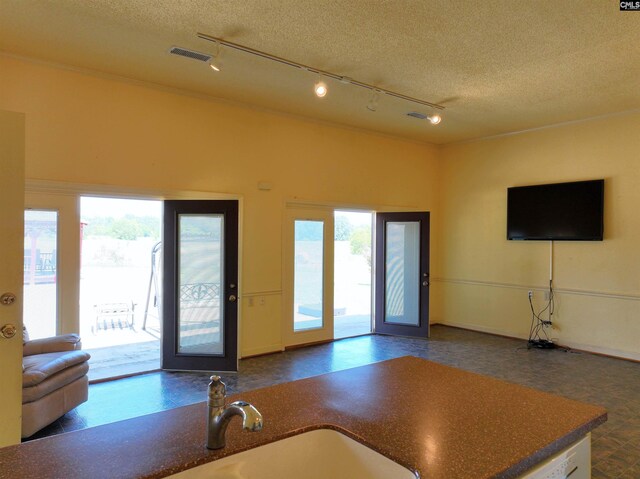 kitchen featuring visible vents, track lighting, open floor plan, and a healthy amount of sunlight