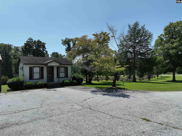 view of front of property with a front yard and fence