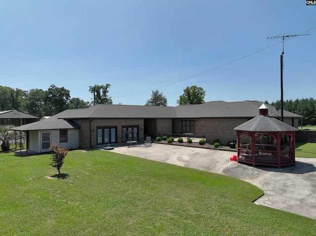 back of house featuring a gazebo, a patio area, a yard, french doors, and brick siding