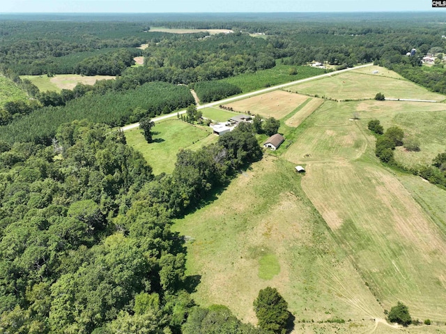 drone / aerial view with a wooded view and a rural view