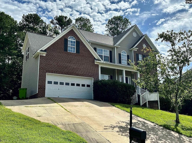 view of front of property with a garage and a front yard