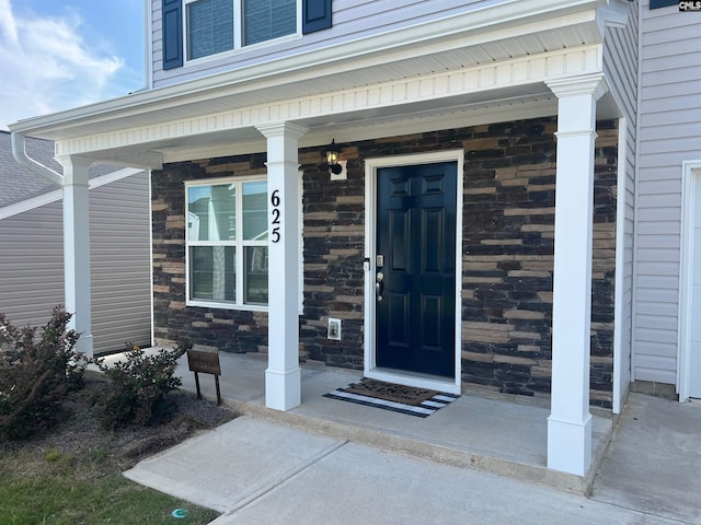 view of exterior entry with covered porch