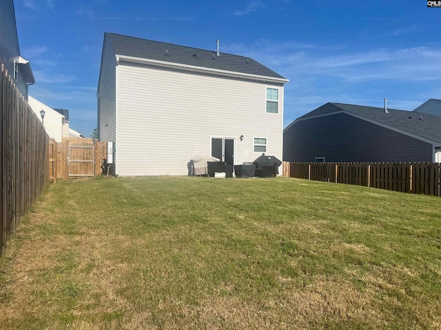 rear view of property featuring a lawn