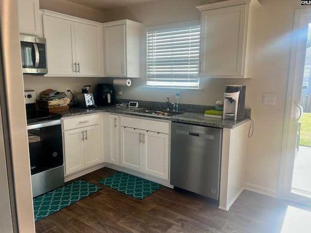 kitchen featuring white cabinets, stainless steel appliances, dark hardwood / wood-style flooring, and sink