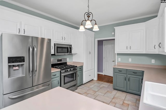 kitchen featuring hanging light fixtures, appliances with stainless steel finishes, and white cabinets