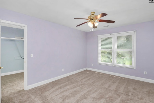 empty room with light colored carpet and ceiling fan